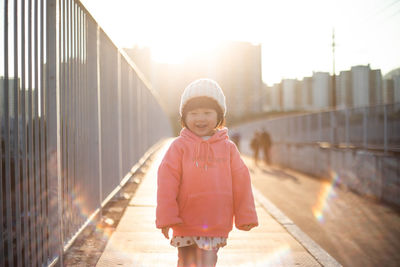 Portrait of smiling girl standing outdoors