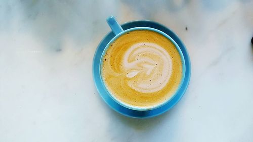 High angle view of cappuccino served on table