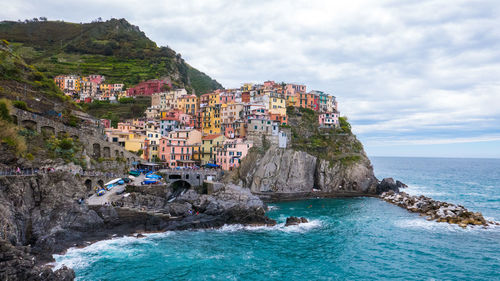 Scenic view of sea and buildings against sky