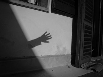 Shadow of person hand on glass window