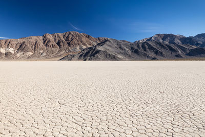 Scenic view of mountains against clear blue sky