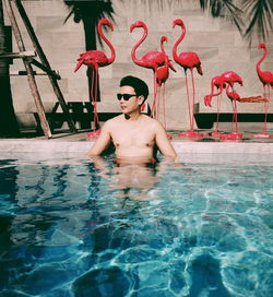 Young man looking at swimming pool