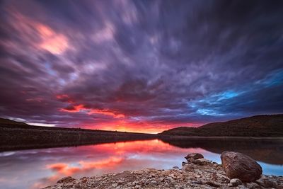 Scenic view of lake against sky at night