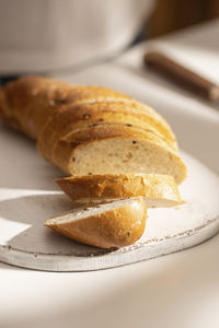 Woman cuts freshly baked bread