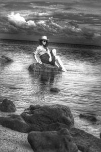 Rear view of woman standing on beach