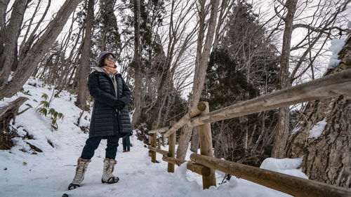 Full length of woman standing on snow