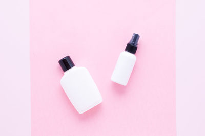 High angle view of bottle on pink over white background