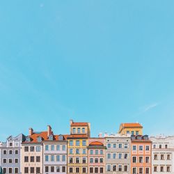 Residential buildings against clear blue sky