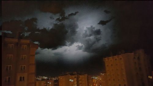 Low angle view of buildings in city at night