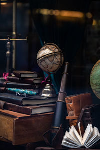 View into antique store with globe, books and telescope