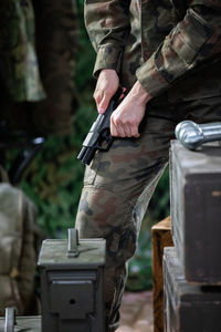 A lady soldier reloads her pistol to keep it charged during an action.