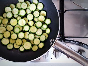 High angle view of zucchini slices cooked on frying pan in kitchen