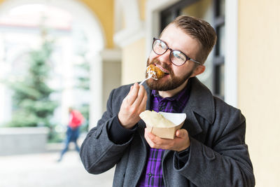 Portrait of young man eating ice cream