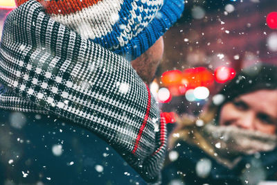 Couple romancing while standing at night during winter