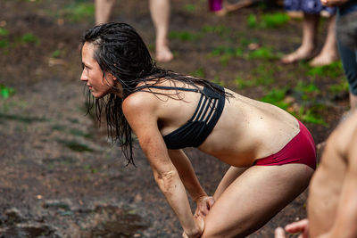 Midsection of woman looking away outdoors