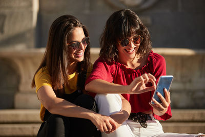 Women sitting on mobile phone