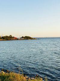 Scenic view of sea against clear sky during sunset