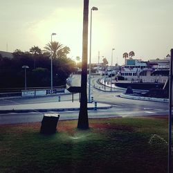 Cars on road against sky in city