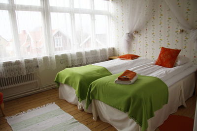 View of messy bed in bedroom