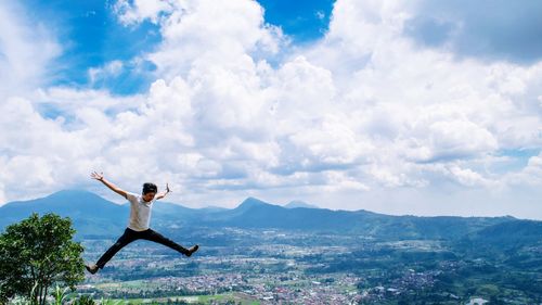 Man jumping against sky