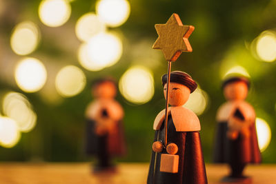 Close-up of figurine on wood