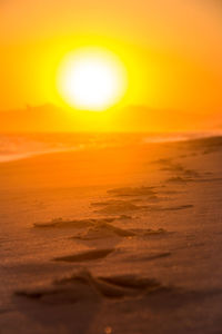 Scenic view of beach against sky during sunset