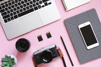 Directly above shot of technologies on pink background