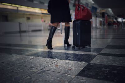 Low section of woman walking in city