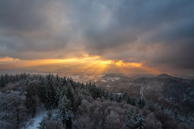 The golden rays of the setting sun shine over the mountains onto the murg valley in the black forest