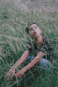 Portrait of woman lying on field