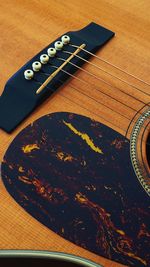 Close-up of guitar on table