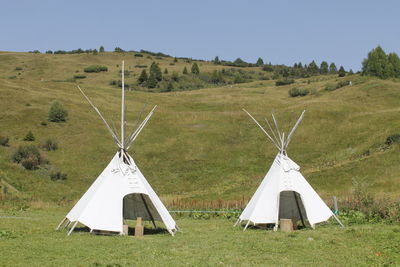 Tent on field against sky