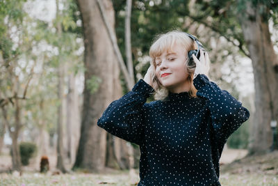 Woman in forest listening music