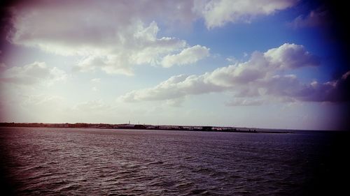 Scenic view of calm sea against cloudy sky