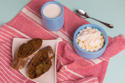 Cottage cheese in a blue bowl with sour cream and honey.