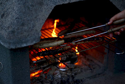 Cropped image of hand holding barbecue grill