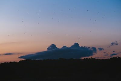 Scenic view of silhouette mountains against sky at sunset