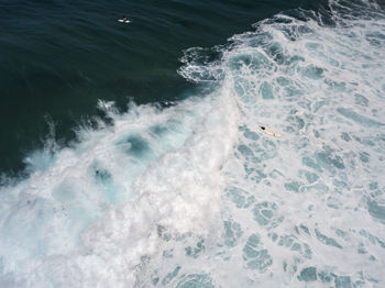 High angle view of waves splashing in sea