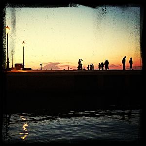 People in water at sunset