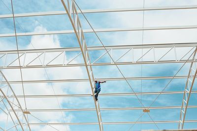 Low angle view of man against blue sky