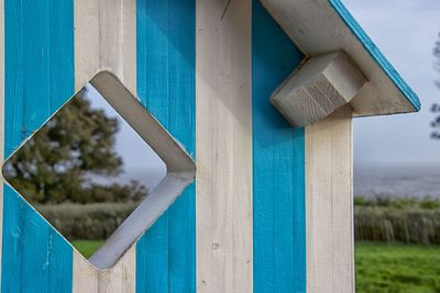 Close-up of birdhouse against blue sky