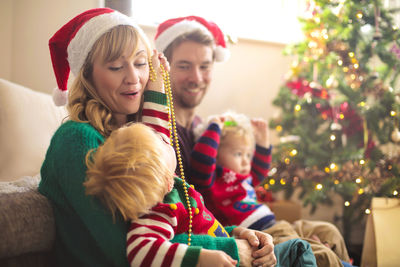Full length of woman with christmas tree