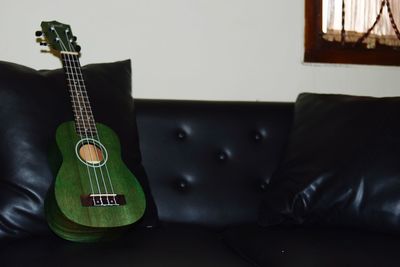 Guitar on sofa at home