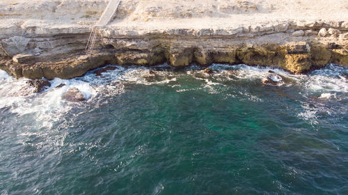 High angle view of rocks in sea