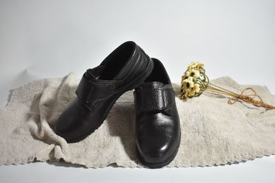 High angle view of shoes on floor against white background