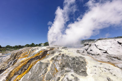 Smoke emitting from volcanic mountain against sky