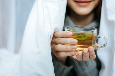 Midsection of woman holding drink