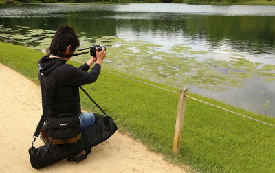 Side view of man fishing at lakeshore