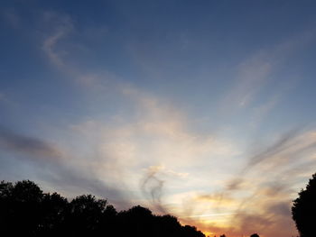 Low angle view of silhouette trees against sky during sunset