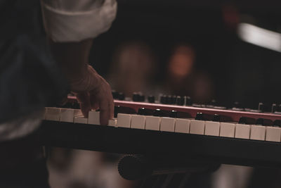 Midsection of man playing piano